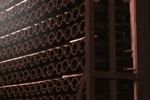 Wine cellar interior and some champagne bottles forming aisles. Stock Photos