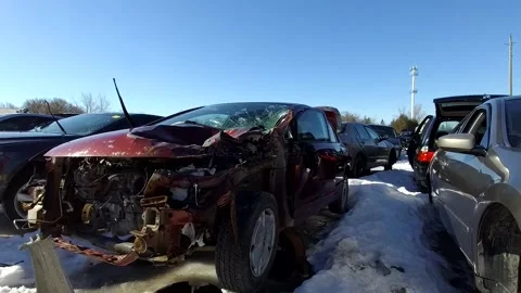 Wine colour Car wreck in a car wreck lot slow-motion tracking shot in the winter Stock Footage
