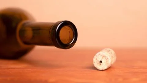 Wine cork and lying empty  bottle  on the table... Wine cork and lying empty  Stock Photos