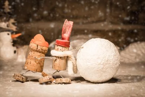 Wine cork figures, concept two men rolling a snowball Stock Photos