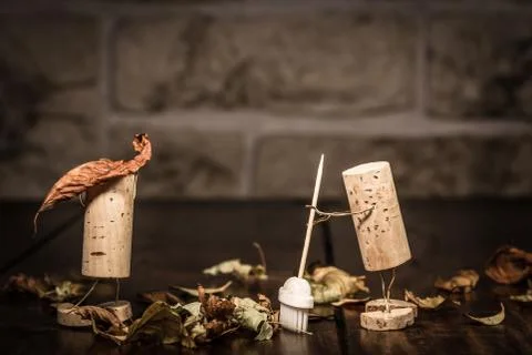 Wine cork figures, concept two men clean up foliage Fotos Stock