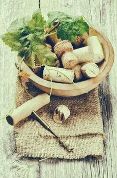 Wine corks and corkscrew in rustic setting Stock Photos