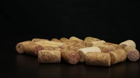 Wine corks on black table. Camera moves from right to left Stock Footage 105745325