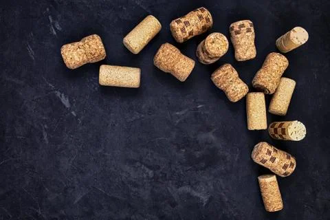 Wine corks on a black textured surface. top view. place for text Stock Photos