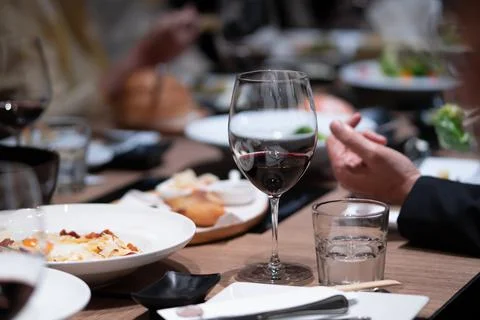 Wine with dinner on the table in a fine restaurant Stock Photos