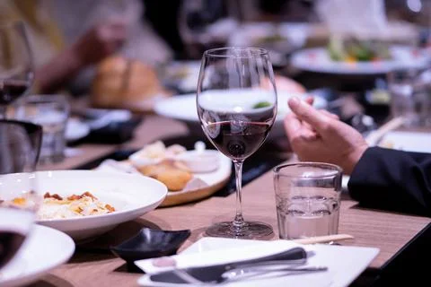 Wine with dinner on the table in a fine restaurant Stock Photos