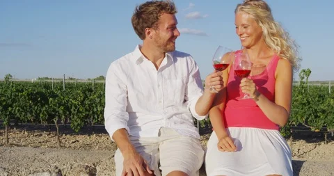 Wine drinking couple happy at vineyard enjoying wine tasting outside Stock Footage 86340481