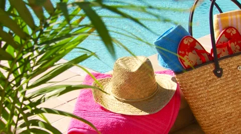 Wine, flip flop, straw hat, sunglasses and bag near poolside Stock Footage 61085024