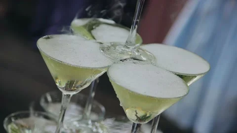 Wine flows down the glasses in a tower of champagne. Close-up shooting Видео 168923236
