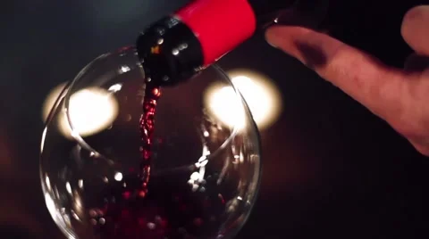 Wine flows in a glass on an evening date in slow motion Video stock 54513220