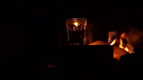 Wine in glass on the background of fire Stock Footage 91183774