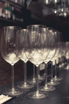 Wine glass on black table setup for party in the bar with vintage color style Stock Photos