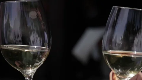 Wine glass hitting each other cheers close up champagne Stock Footage 75736176