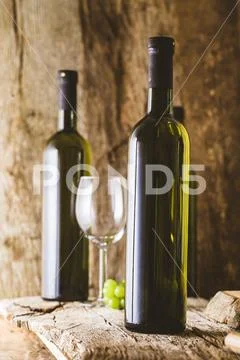 Wine. Glass of white wine in wine cellar. Old white wine on wood. Stock Photos