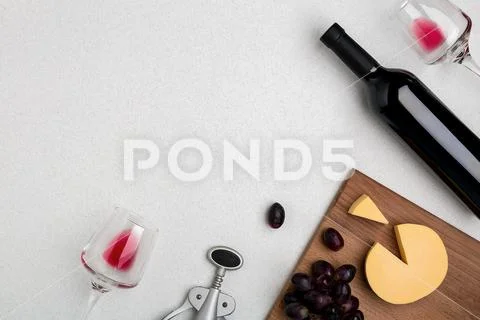 Wine, glasses and corkscrew over white background. Top view Stock Photos