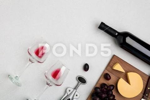 Wine, glasses and corkscrew over white background. Top view Stock Photos