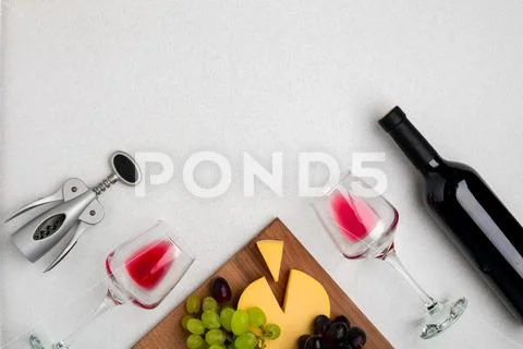 Wine, glasses and corkscrew over white background. Top view Stock Photos