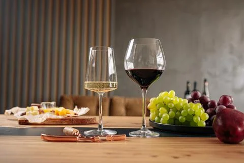 Wine glasses with appetizers on table Stock Photos