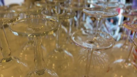 Wine glasses arranged upside down creating reflective pattern background Stock Footage 327810972