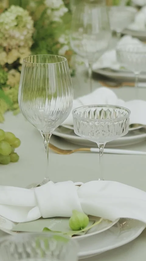 Wine glasses on the festive table at the wedding. Table setting with white Stock Footage 308398446