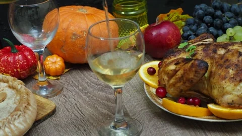Wine glasses in front of chicken dinner, pour wine Thanksgiving  Christmas Stock Footage 257599566