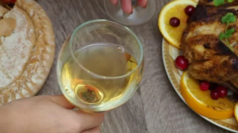 Wine glasses in front of chicken dinner, pour wine Thanksgiving  Christmas Stock Footage 257599669