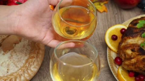Wine glasses in front of chicken dinner, pour wine Thanksgiving  Christmas Stock Footage 257599732