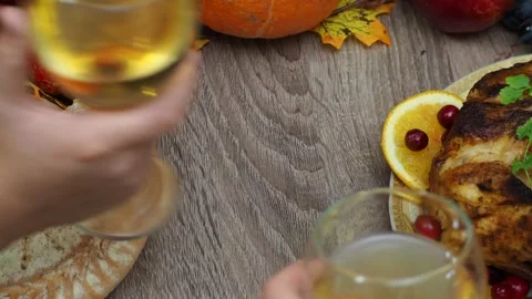 Wine glasses in front of chicken dinner, pour wine Thanksgiving  Christmas Stock Footage 257599973