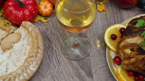 Wine glasses in front of chicken dinner, pour wine Thanksgiving  Christmas Stock Footage 257600436