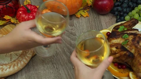 Wine glasses in front of chicken dinner, pour wine Thanksgiving  Christmas Stock Footage 257601255