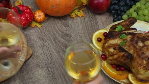 Wine glasses in front of chicken dinner, pour wine Thanksgiving  Christmas Stock Footage 257601323