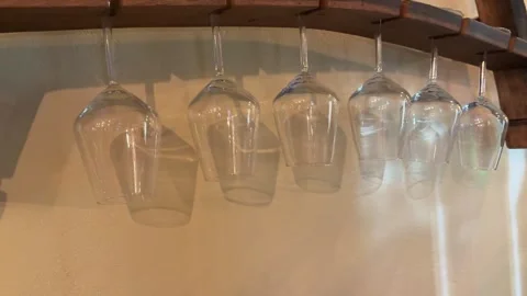 Wine glasses hang from the ceiling of the bar Vídeo Stock 326464584