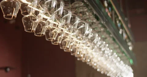 Wine glasses hanging on rack in bar Stock Footage 239165945
