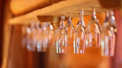 Wine glasses hanging upside down in the bar Stock Footage 46015346