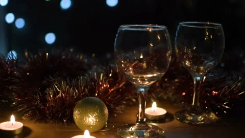 Wine glasses. Light garlands in the background. Celebration. Video stock 97366511