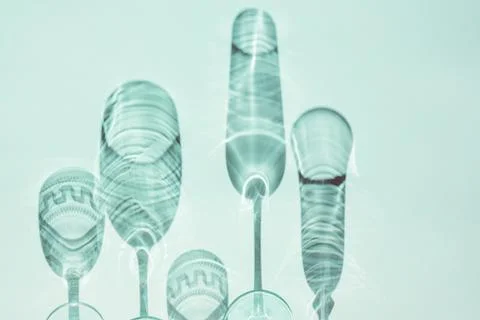Wine glasses on a sunny table cast shadows Stock Photos