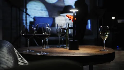 Wine glasses on the table, evening lighting Stock Footage 225895384