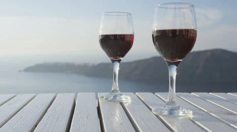 Wine glasses On Table Filled with Red Wine - romantic setting outdoors Stock Footage 61505239