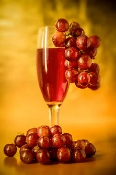 Wine, grape wine in cups, laid led berry grapes on the table Stock Photos