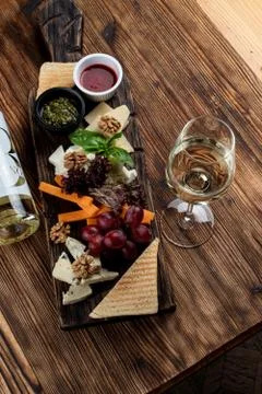 Wine platter with assorted snacks such as grissini, cheese, sliced meat and n Stock Photos