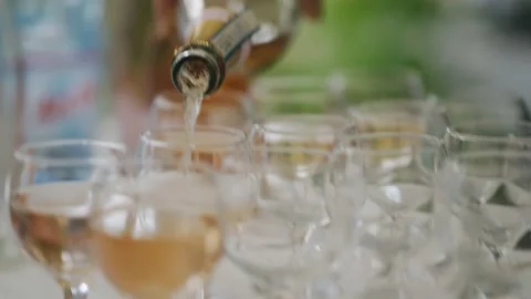 Wine is poured from a bottle into glasses Stock Footage 220148051