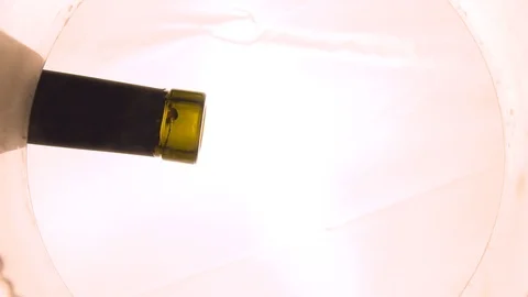 Wine is poured into a glass, view from the nirzu, transparent bottom Stock Footage 101471483