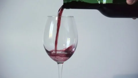 Wine is poured into a transparent empty glass from a bottle. Slow Motion Video Stock Footage 105894369