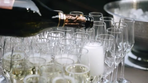 The wine pours from the bottle into the glasses Stock Footage 342030901