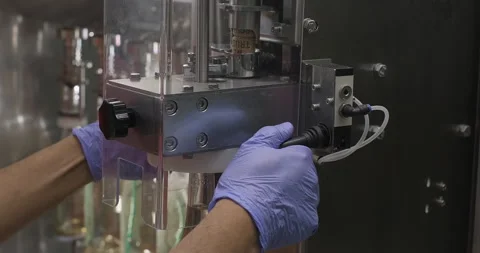 Wine production process. Factory worker sealing wine bottle with a cork. Slow Stock Footage 247952973