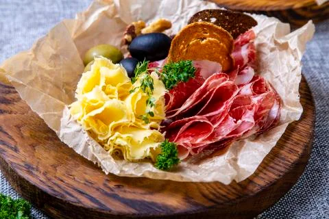 Wine sets: dried neck, cheese, olives and rye crackers. Seth is lying on crum Stock Photos