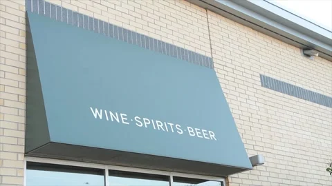 Wine spirits beer white writing caption text on side of store building Stock Footage 251370017