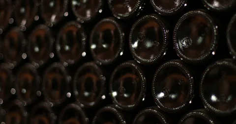 Wine storage in dark bottles, stacked. Texture of bottom of glass bottles Видео 95148243