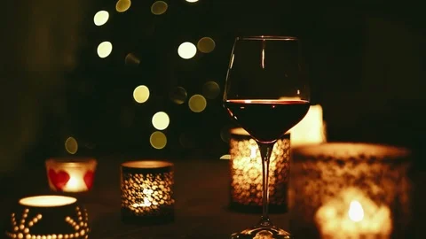 Wine on the table as Christmas tree flickers in the background Stock-Footage 93053412