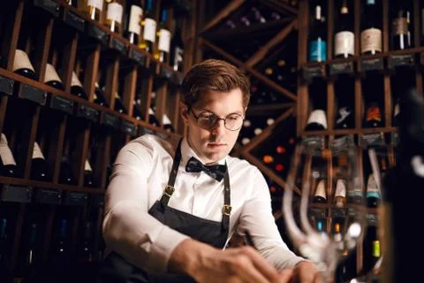 Wine taster writing in notepad information of wine origin and taste. Stock Photos